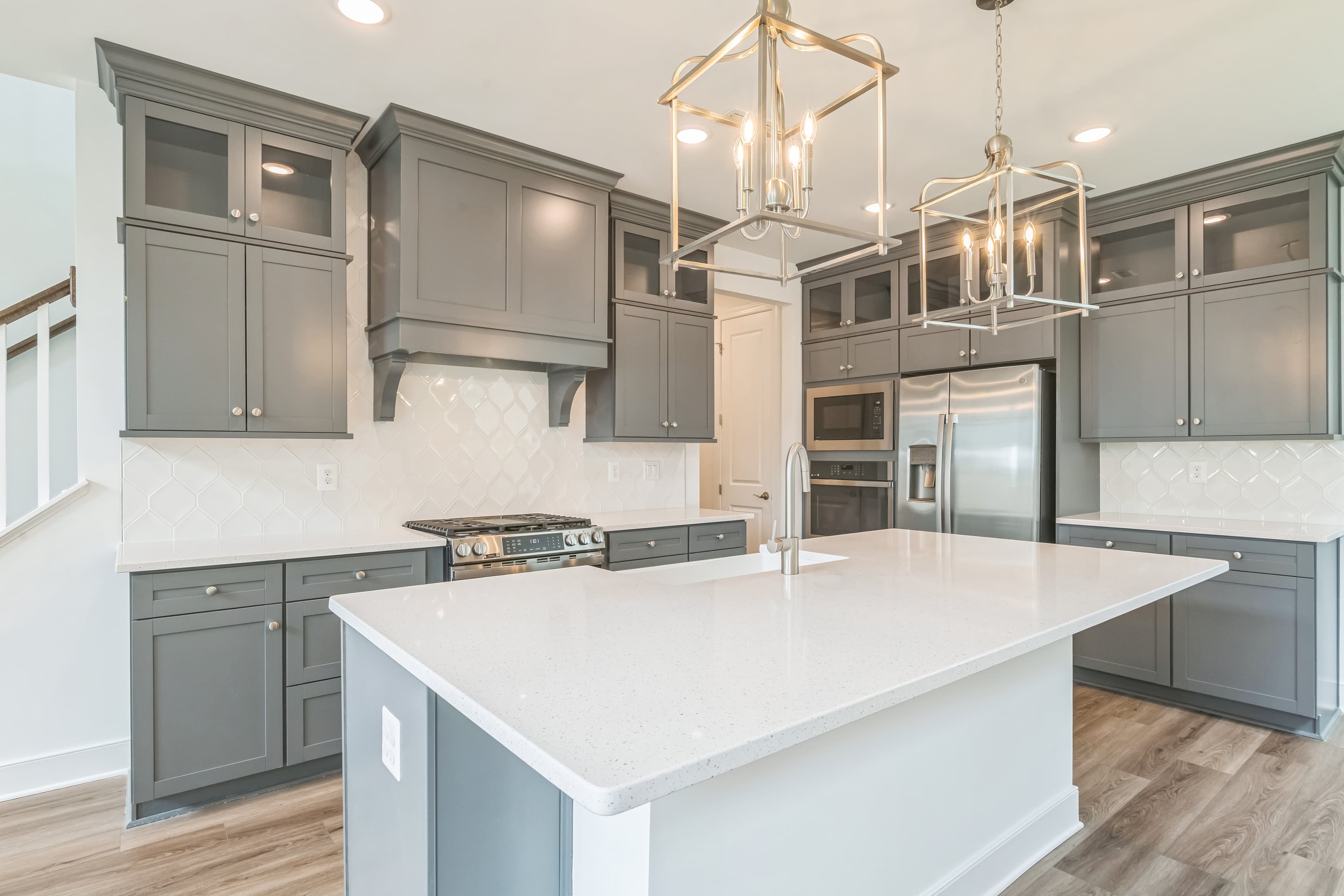 Kitchen with stacked glass-front upper cabinets