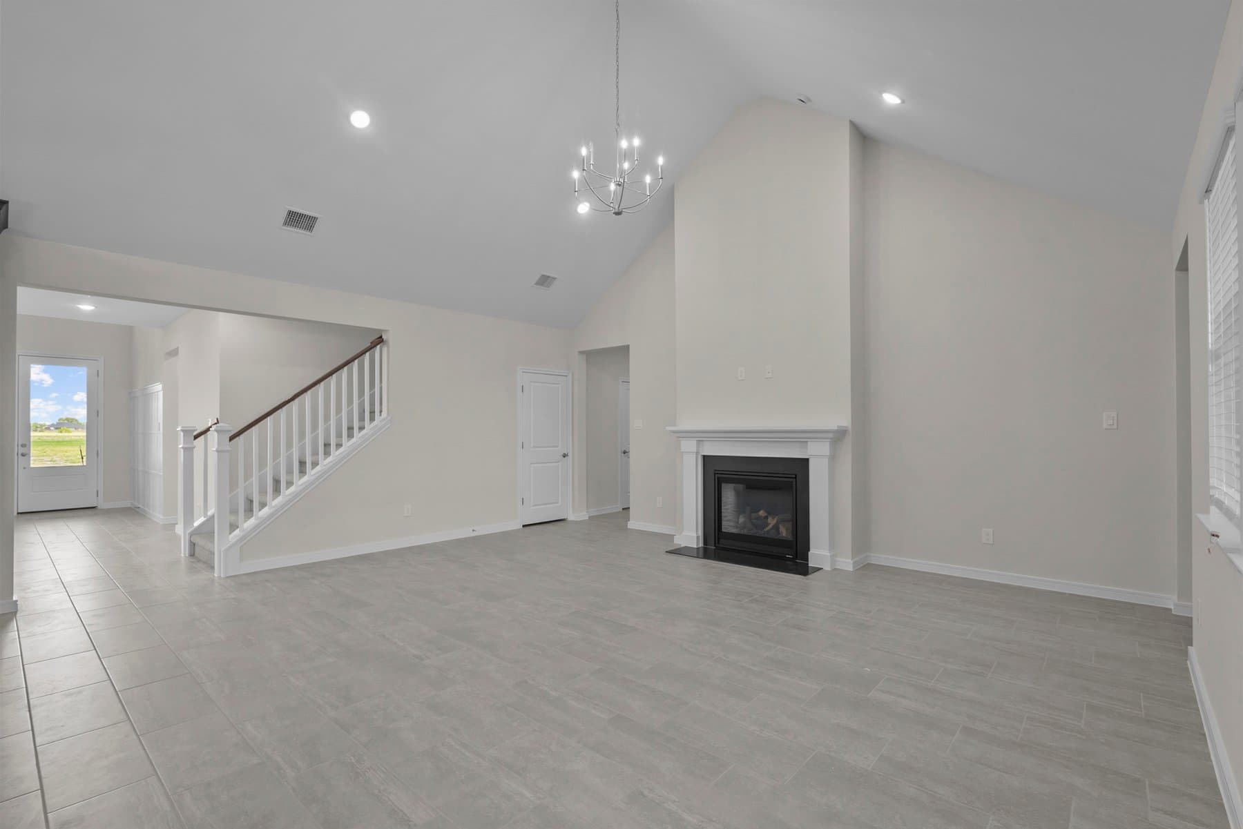 Great room with chandelier & fireplace
