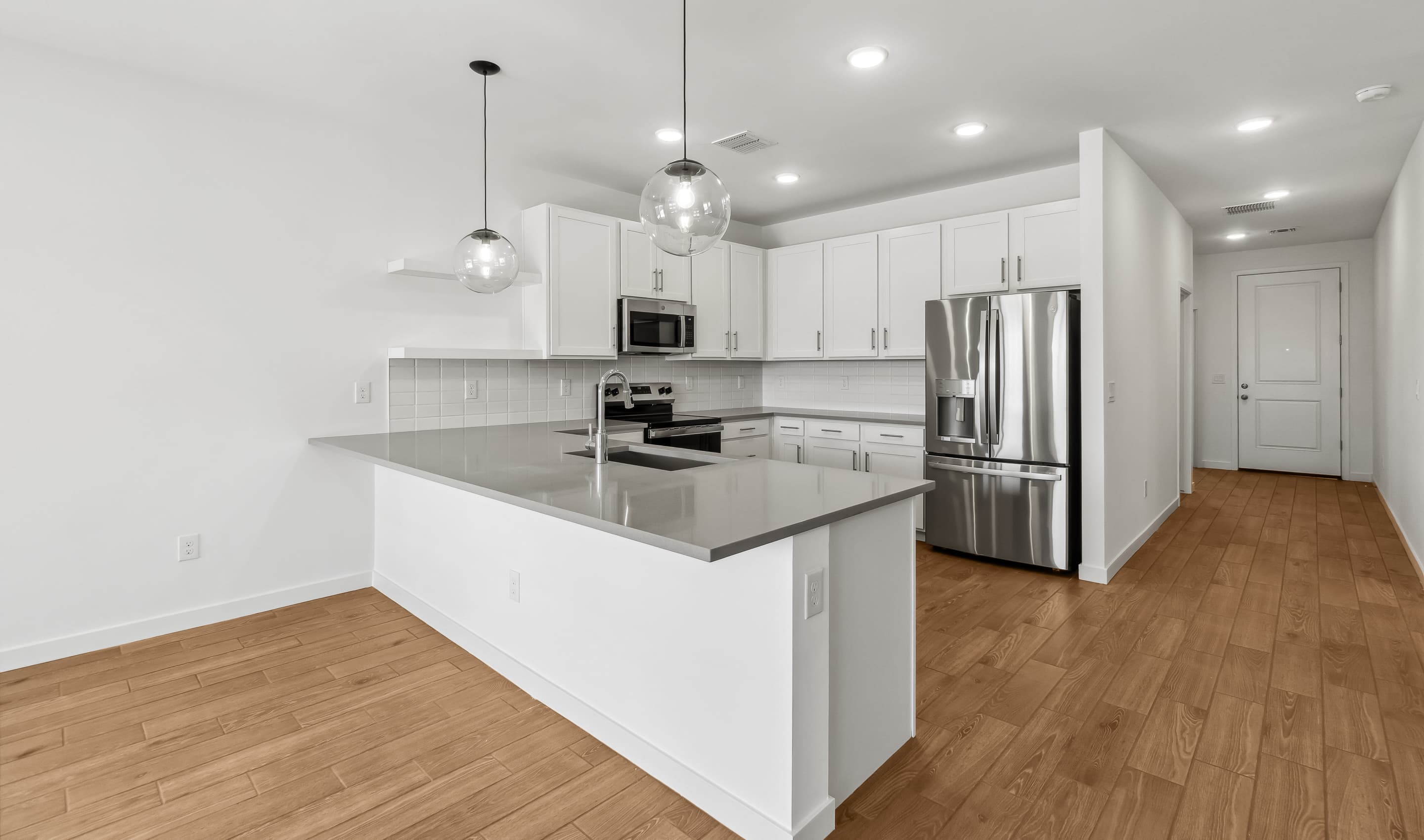 Kitchen with white cabinetry and quartz countertop
