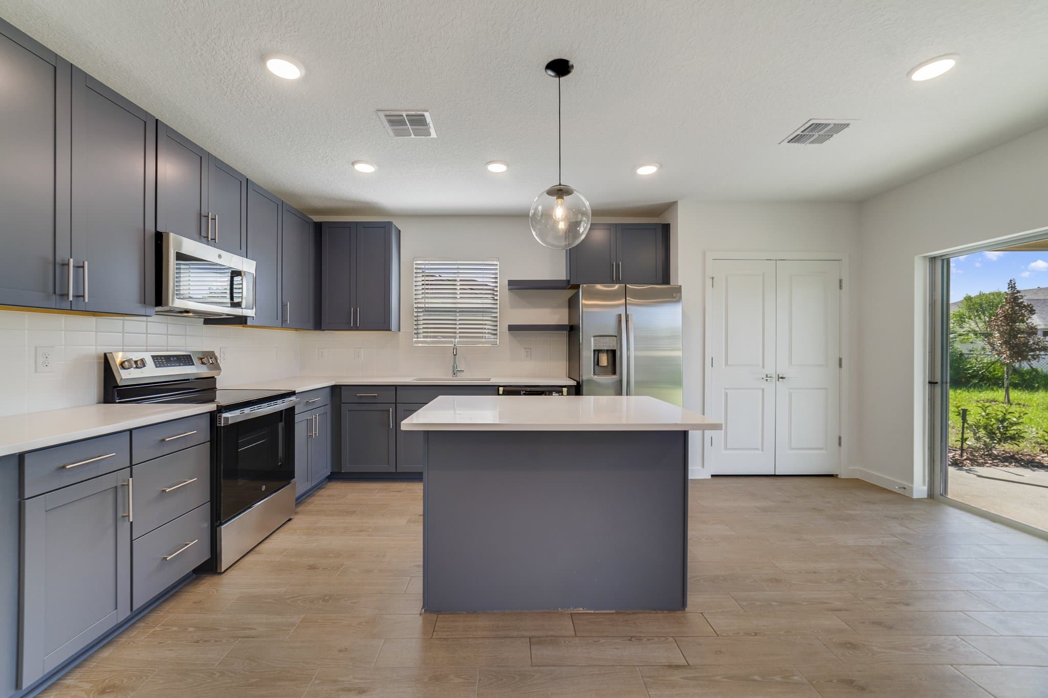 Kitchen featuring center island & floating shelves