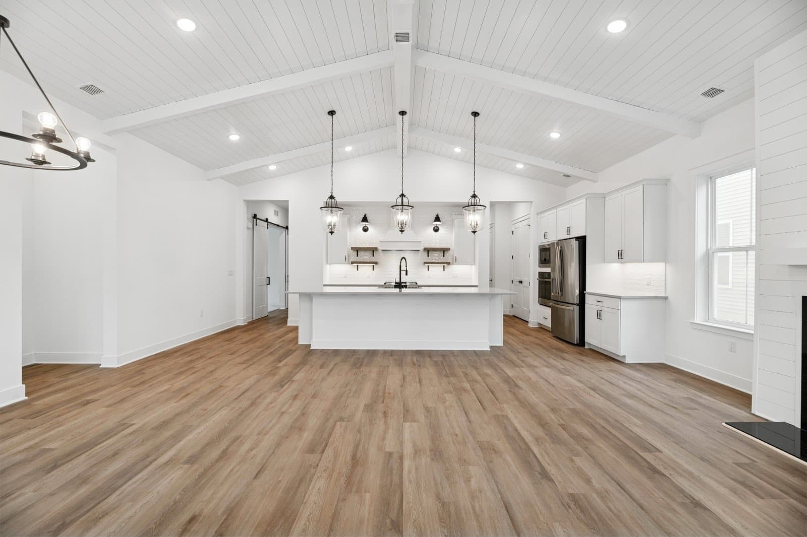 Vaulted ceiling showcases painted beams & shiplap detail