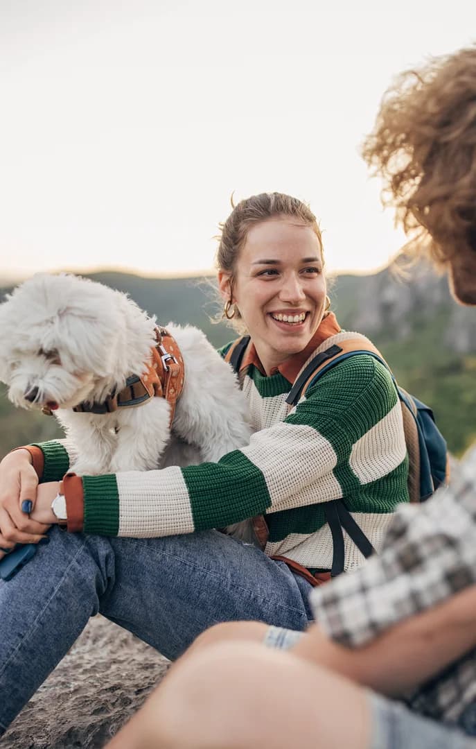 Young Couple or Friends on Top of Mountain Hiking with Dog