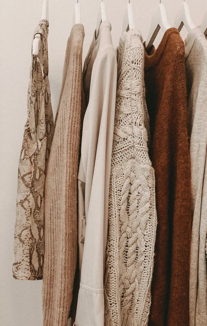 Beige and Brown Clothing Hanging on Shop Rack