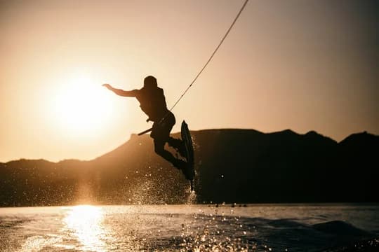 Person wake boarding on body of water