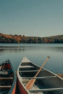 Canoes Along a Lake with Fall Trees in Background