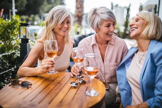 Older Women Enjoying Wine Outside