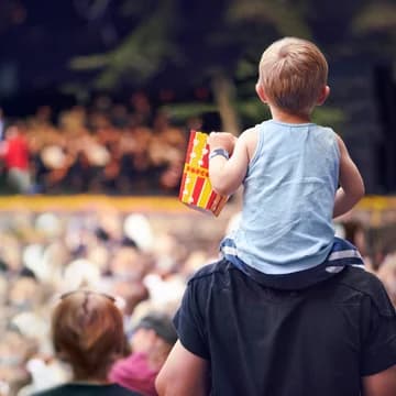 Little Boy on Father s Shoulders at an Outdoor Concert Event