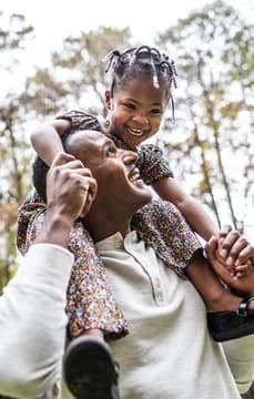 139764 Father Carrying Daughter on Shoulders Smiling in Front of Home USP Crop