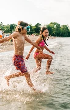 Kids at the Lake Shore Jumping into the Water
