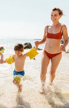 139834 Happy Family Running and Splashing Along the Shore USP Crop