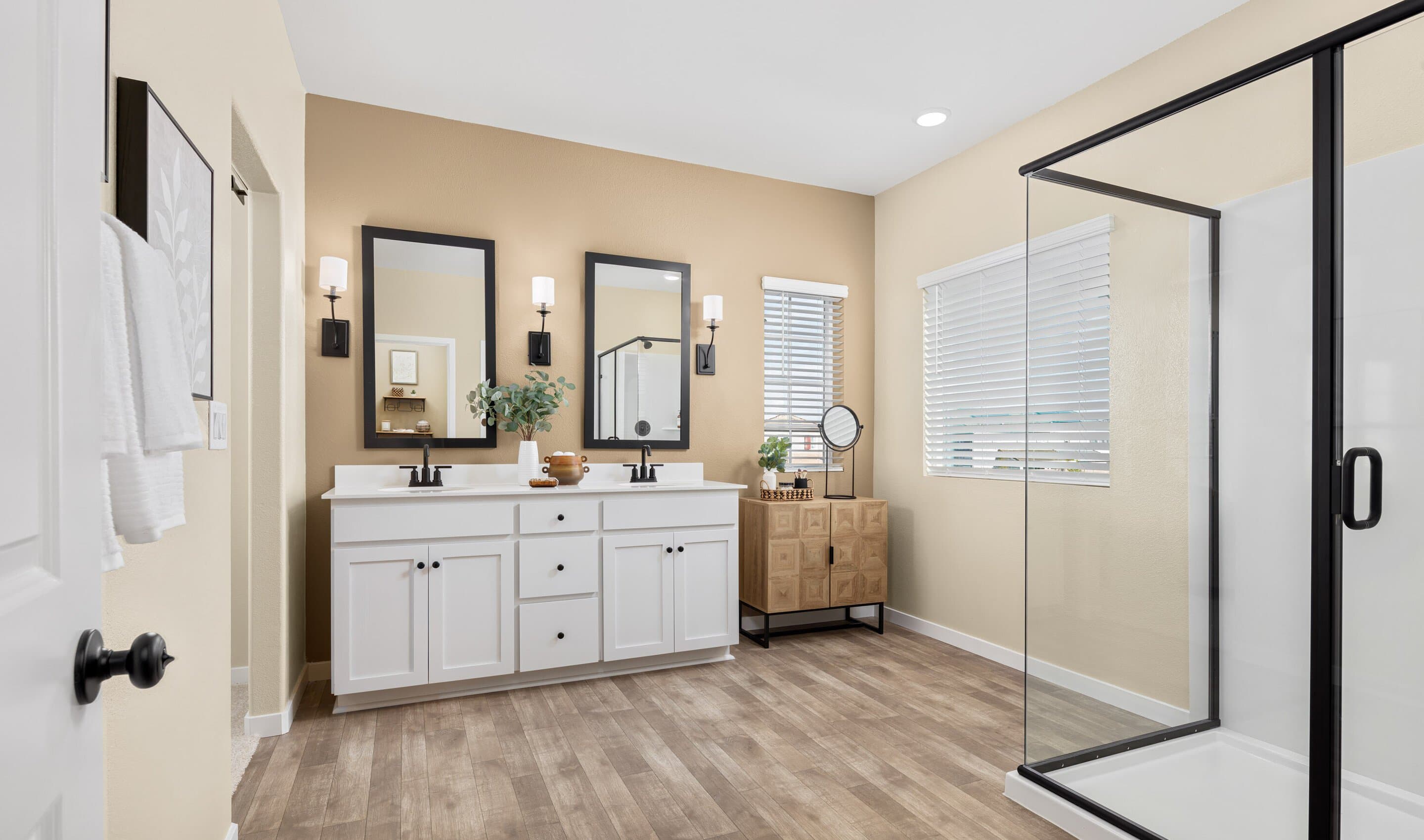 Primary bath with glass shower enclosure and vanity