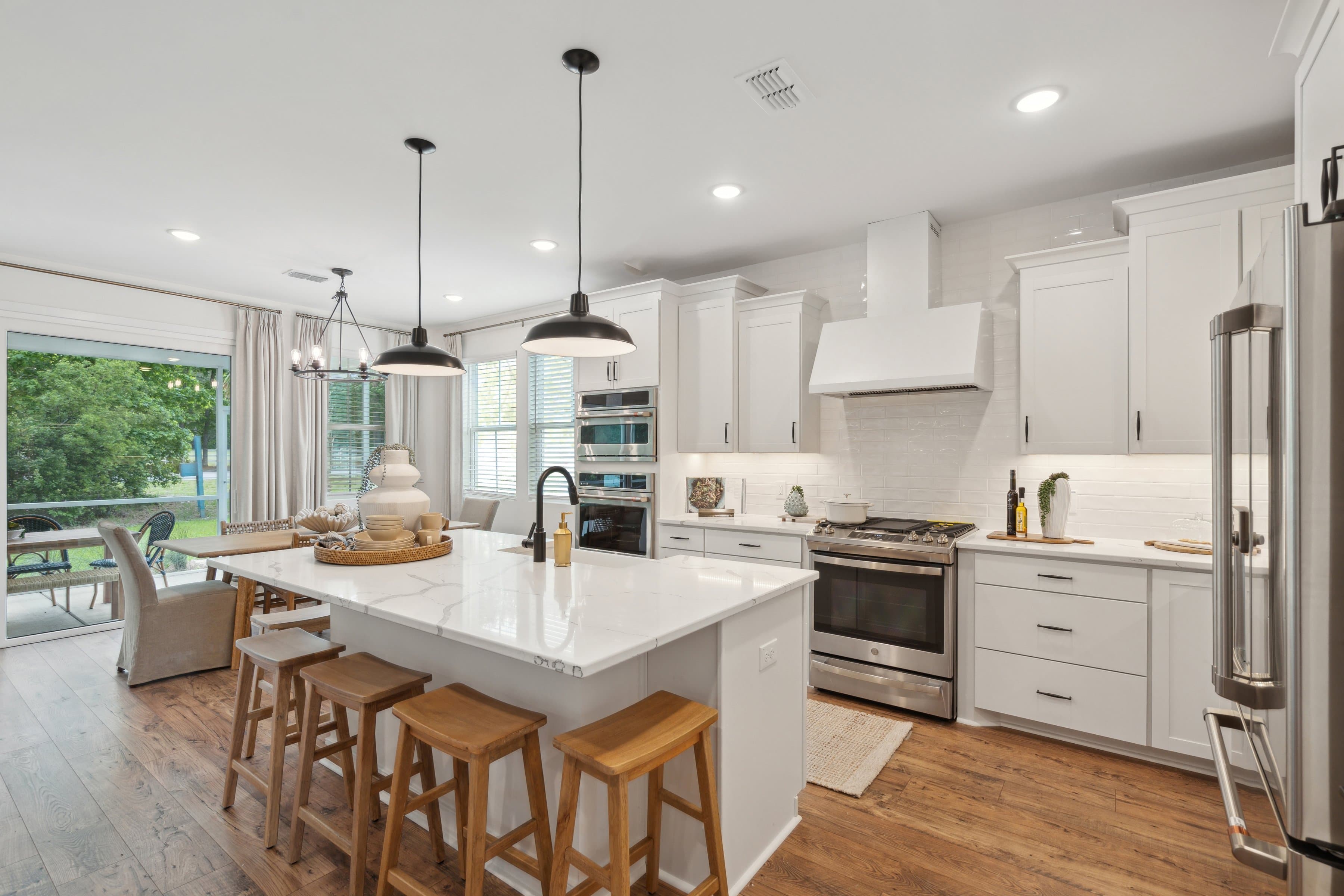 Kitchen with white cabinetry & quartz countertop