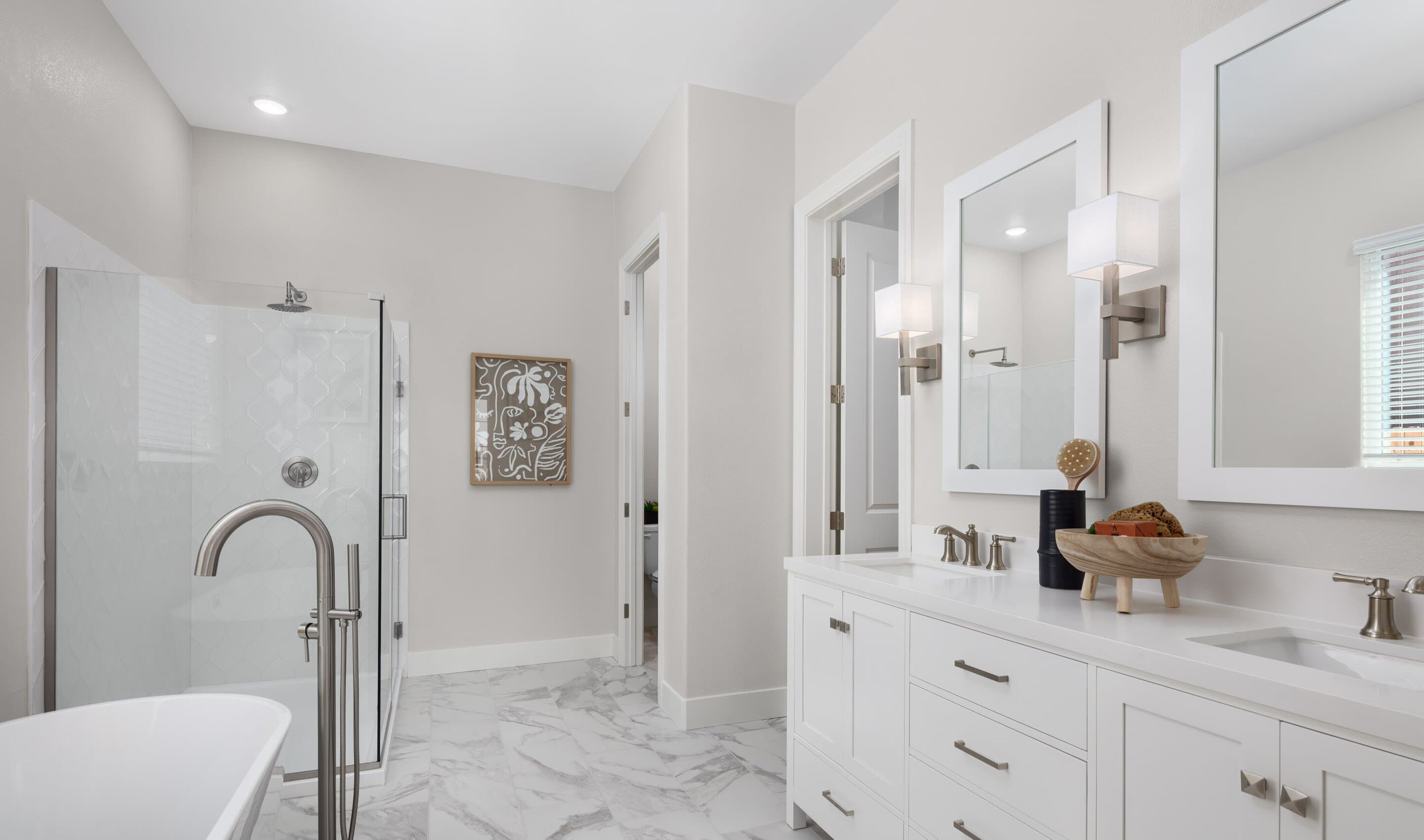 Primary suite with freestanding vanity and freestanding tub