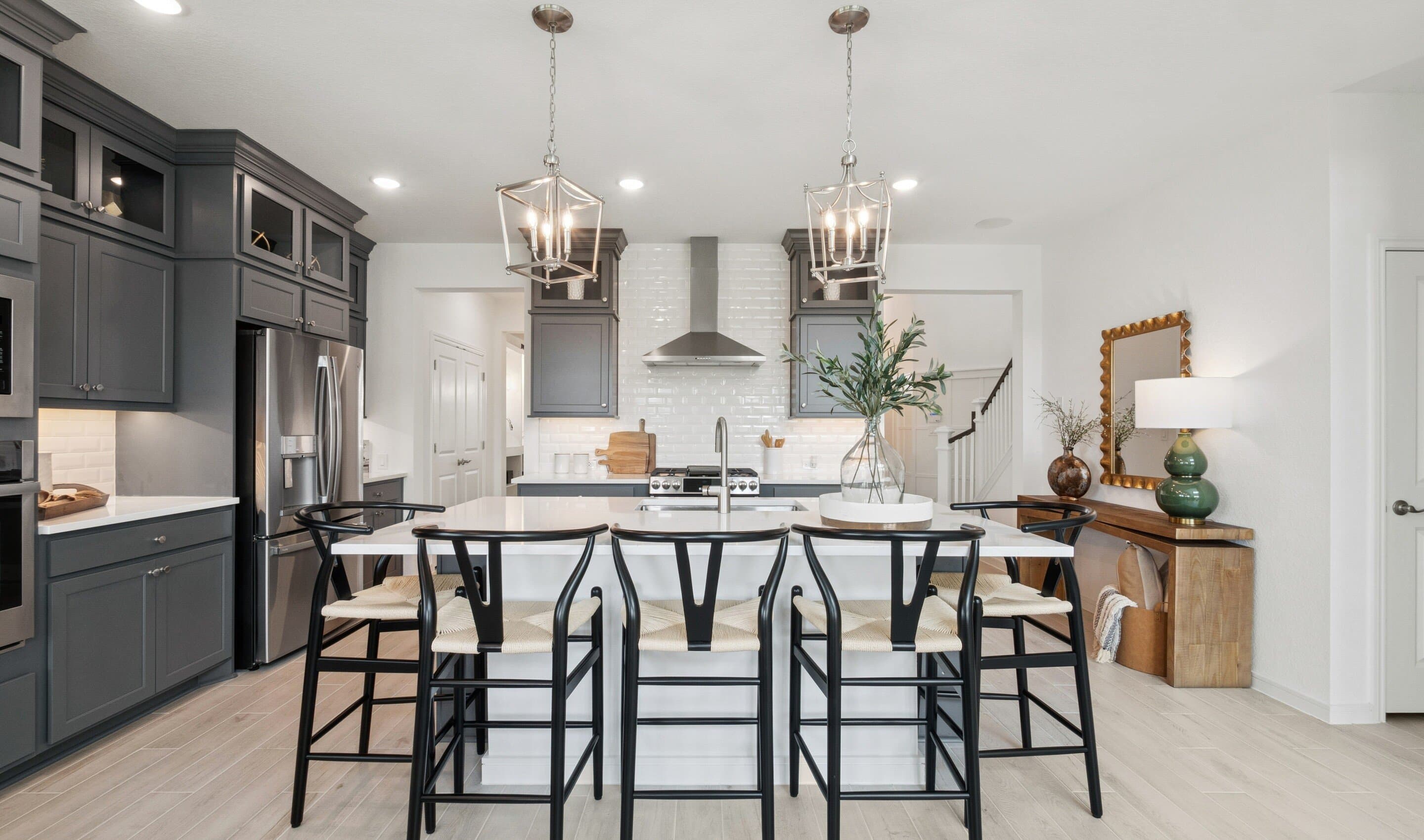 Kitchen showcases stacked cabinetry with glass-front uppers